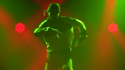 Silhouette of a talented young break dancer. Hip hop street dance on a stage in Stock Footage 138918158