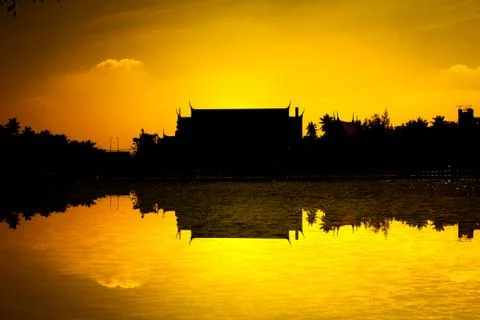 Silhouette temple with river reflection sunset Stock Photos