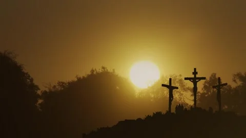 Silhouette of three crosses on Calvary at sunset with people gathered Stock Footage 340260367