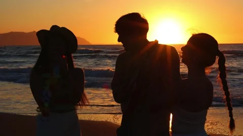 Silhouette of three multiracial friends clapping while playing the ukulele .. Stock Footage 273921794