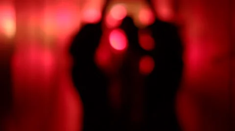 Silhouette of three sexy women dancing in a blurry, red corridor Stock Footage 59553283