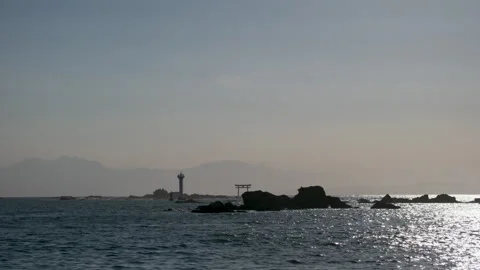 Silhouette of a Torii Gate and Lighthouse on the Ocean Coast near Kamakura Stock Footage 337692275