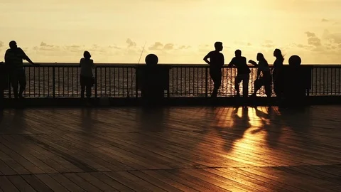 Silhouette of tourists at the coast park Stock Footage