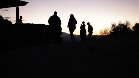 A silhouette of tourists at sunset Stock Footage 58654131