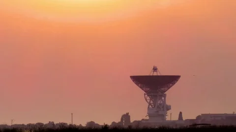 Silhouette of tower with radar communication system at sunset Stock Footage 78050131