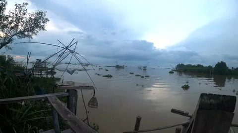 Silhouette of traditional fishing method using a bamboo square dip Stock Footage 176467809