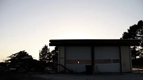 Silhouette of trash dump next to garage Stock Footage 95112403