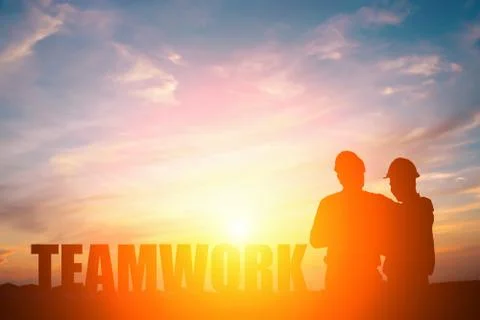 Silhouette of two engineers in sunset, teamwork concept. Stock Photos