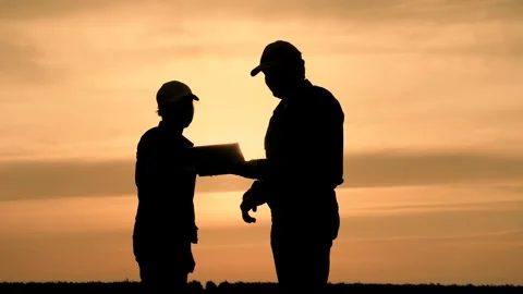 Silhouette two farmers work tablet, farming, teamwork group people, contract Stock Footage 245038331