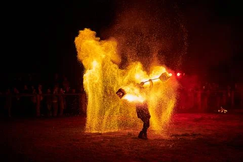 Silhouette of Two Fire Performers Creating Sparks Against Night field Stock Photos