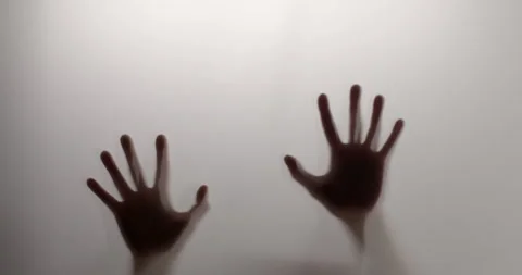 Silhouette. Two hands appear and scratch down. Abstract Stock Footage 133933472