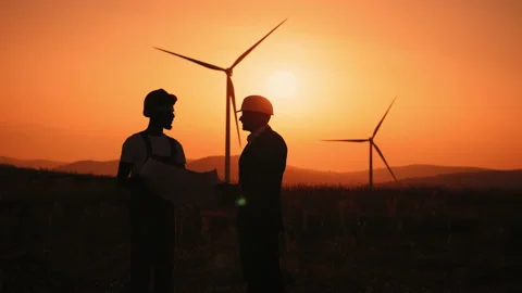 Silhouette Two multiracial industrial workers examining wind turbines blueprints Stock Footage 170659658