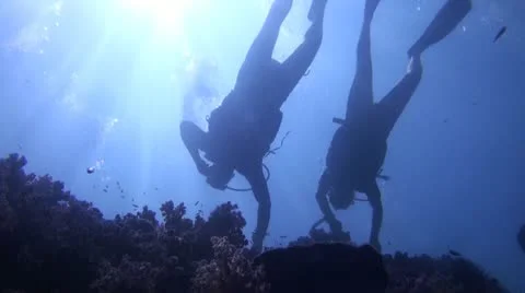 Silhouette of two scuba Divers Stock Footage 22303798