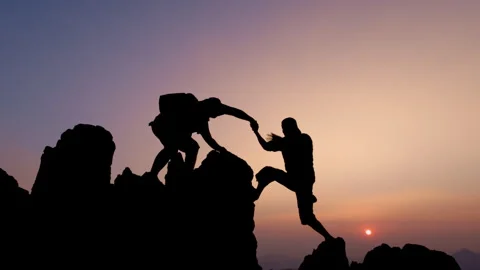Silhouette of two tourists lends helping hand climb cliffs mountains helpin.. Stock Footage 336955270