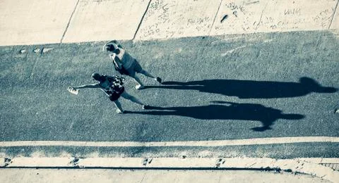 Silhouette of a two womans casting a long shadow Stock Photos