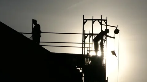 Silhouette unrecognizable construction worker sending down a Drill using crane Stock Footage 67895797