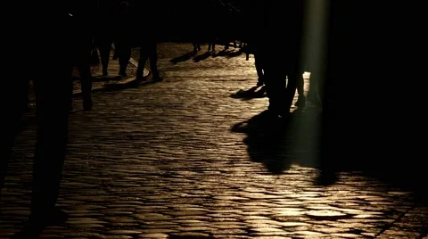 Silhouette unrecognizable crowd of people walking in the street with sunlight Stock Footage