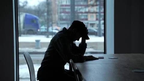 Silhouette of a upset man on the background of the window Stock Footage 151474072