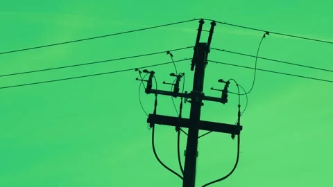 Silhouette of utility pole with power lines against a green background Stock Footage 346803569