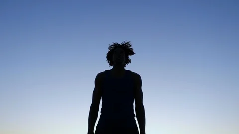 Silhouette of a victorious man at sunset. Stock Footage