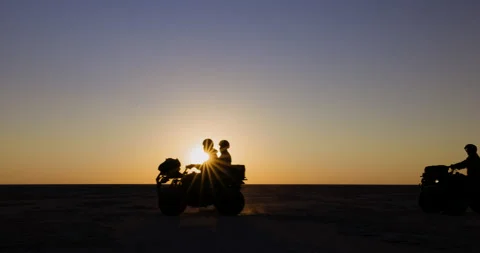 Silhouette view of tourists having fun riding quad bikes in the wide open spaces Stock Footage 155425488