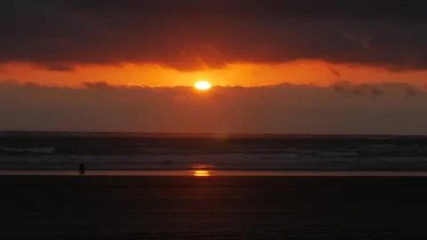 Silhouette walking along beach at sunset Video stock 346327770