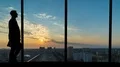 The silhouette of walking people on a city view background in an airport window 4k or 4k+ Resolution