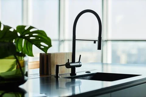Silhouette of Water Tap over Sink Installed on Marble Countertop in Kitchen Stock Photos