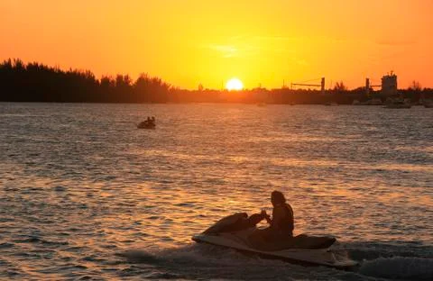 Silhouette of waterbike at sunset, boca chica bay Stock Photos