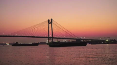 A silhouette wide shot of the cable-stayed river bridge against the sunset sky. Stock-Footage 267911884