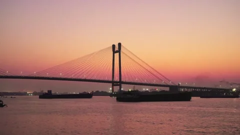 A silhouette wide shot of modern cable-stayed sea link bridge against sunset sky Video stock 267911028