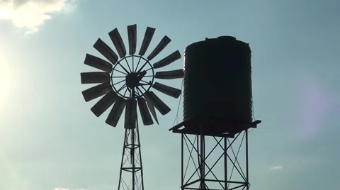 Silhouette of windmill spinning fast in the wind CU Video stock 56955341