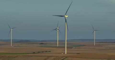 Silhouette of a windmill in the sun. Aerial close up shot of wind mills rotating 库存影片 247020152