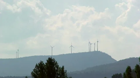 Silhouette of windmills on crest, clouds in the sky Stock Footage 50078721