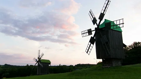Silhouette of windmills at sunset time lapse Stock Footage 86084385