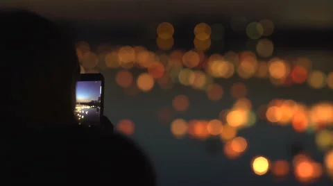 Silhouette of a woman with a phone. Festival of water lanterns Stock Footage