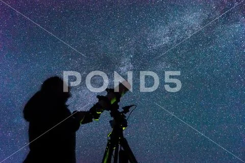Silhouette of a woman with a telescope Stock Photos