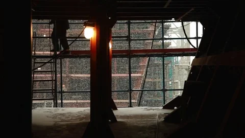 Silhouette of worker in construction site with snow background Видео 73365116