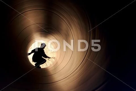 A silhouette of a worker in pipe Stock Photos