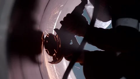 Silhouette of a worker while cleaning welds Stock Footage 170698794