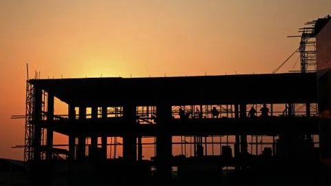 Silhouette workers at the construction site Stock Photos