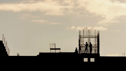 Silhouette workers on construction site working with steel rebar sunny evening Stock Footage 108120099