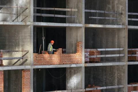 Silhouette Workers under Building Construction Stock Photos