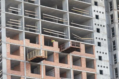 Silhouette Workers under Building Construction Stock Photos