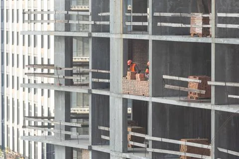 Silhouette Workers under Building Construction Stock Photos