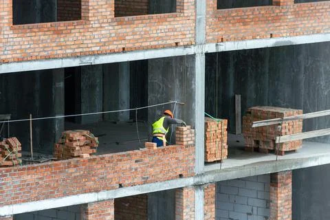 Silhouette Workers under Building Construction Stock Photos