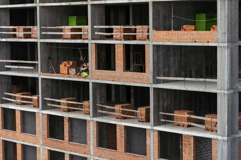 Silhouette Workers under Building Construction Stock Photos