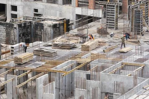 Silhouette Workers under Building Construction Stock Photos