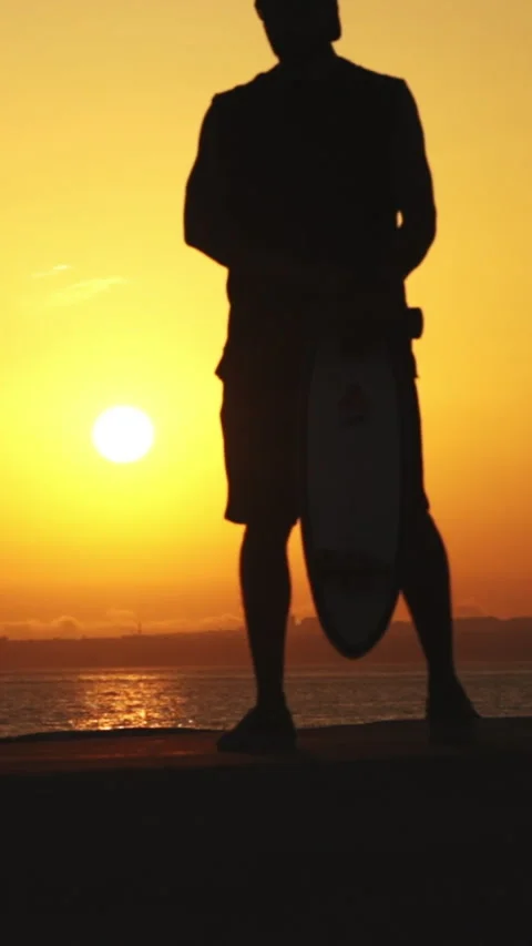 Silhouette of a young athletic man skating on a skateboard at bright sunset Stock Footage 328579245