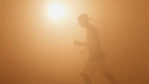 Silhouette of young b-boy breakdancing and doing handstand moves Stock Footage 132070668